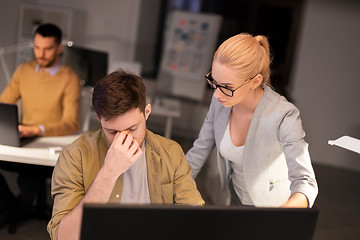 Image showing business team with computer working late at office