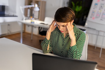 Image showing stressed businesswoman at night office