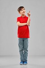 Image showing little boy in red polo t-shirt pointing finger up