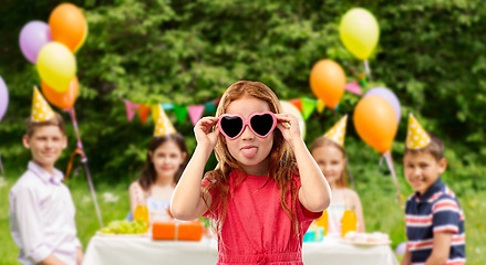 Image showing naughty red haired girl in heart shaped sunglasses