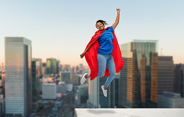 Image showing happy african american woman in superhero red cape