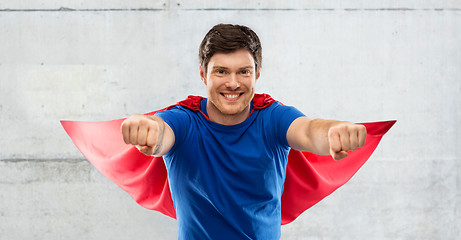 Image showing man in red superhero cape over concrete background