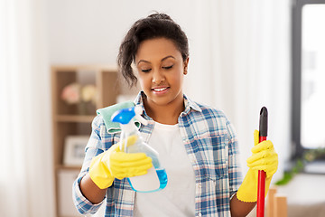 Image showing african american woman with detergent at home