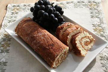 Image showing Pastry with almond cream - blue grapes in background