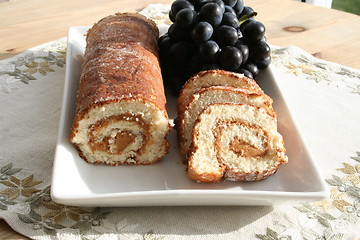 Image showing Pastry with almond cream - blue grapes in background