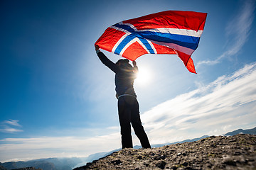 Image showing Woman with a waving flag of Norway on the background of nature