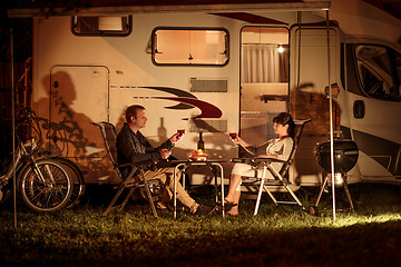 Image showing Adult couple clinking glasses of wine. Family vacation travel RV