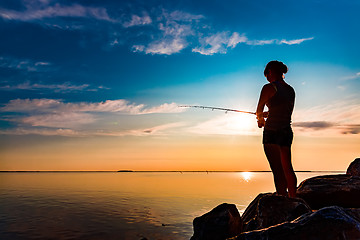 Image showing Woman fishing on Fishing rod spinning in Norway.