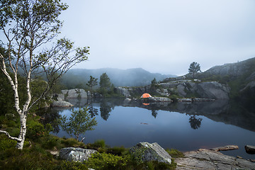 Image showing Tourist tent on the shore of a lake in the mountains. Beautiful 