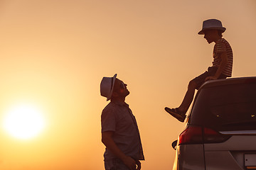 Image showing Father and son playing in the park at the sunset time.