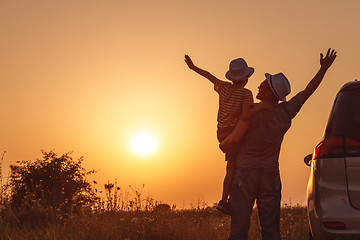 Image showing Father and son playing in the park at the sunset time.