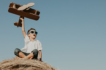 Image showing Happy little boy playing  in the park at the day time. 