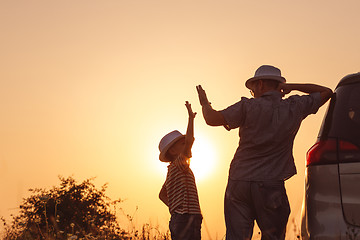 Image showing Father and son playing in the park at the sunset time.