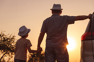 Image showing Father and son playing in the park at the sunset time.