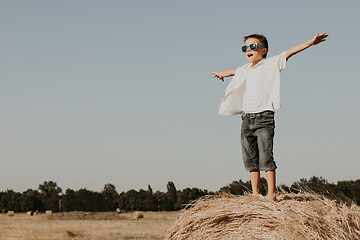 Image showing Happy little boy playing  in the park at the day time.