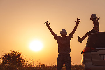 Image showing Father and son playing in the park at the sunset time.