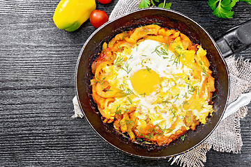 Image showing Scrambled eggs with vegetables in pan on board top