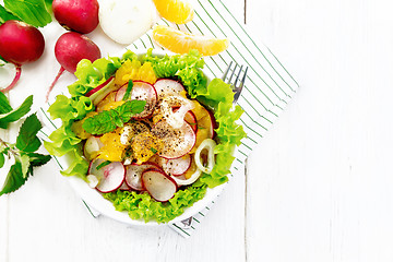 Image showing Salad of radish and orange with mint on board top