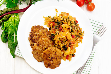 Image showing Fritters meat with cabbage in plate on light board top