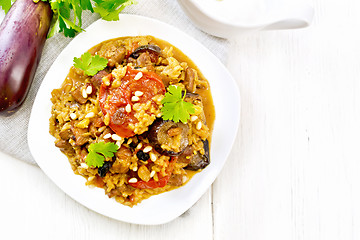 Image showing Rice with vegetables and chicken in plate on light board top