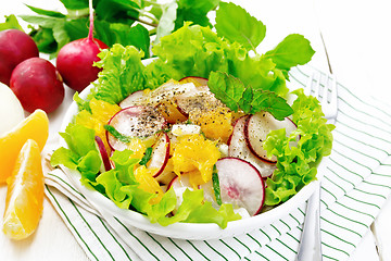 Image showing Salad of radish and orange with mint on white wooden board