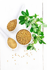 Image showing Fenugreek in bowl and two spoons with leaves on light board top