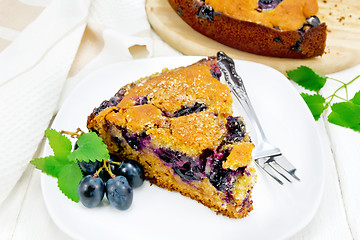 Image showing Pie with black grapes  in plate on white board