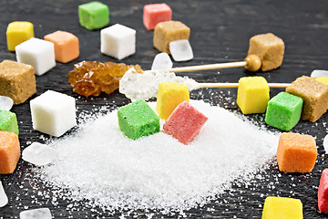 Image showing Sugar of different colors and shapes on black board