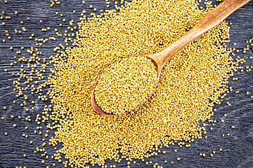 Image showing Mustard seeds in spoon on black board top