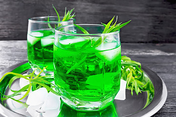 Image showing Lemonade Tarragon with ice in two glasses on wooden board