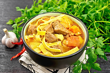 Image showing Lagman in bowl on black board