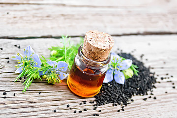 Image showing Oil kalingi in bottle on old wooden board