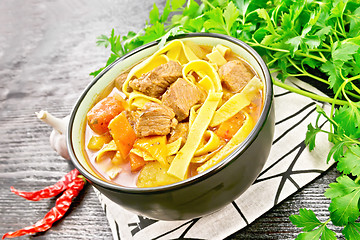 Image showing Lagman in bowl on black wooden board