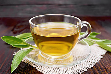 Image showing Tea herbal with sage in glass cup on dark board