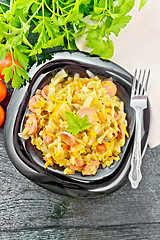 Image showing Cabbage stew with sausages in plate on board top