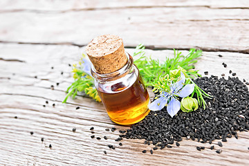 Image showing Oil kalingi in bottle on wooden board