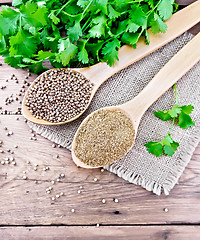 Image showing Coriander ground and seeds in two spoons on old board top