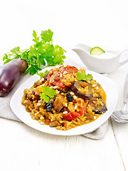 Image showing Rice with vegetables and chicken in plate on white wooden board