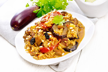 Image showing Rice with vegetables and chicken in plate on light wooden board