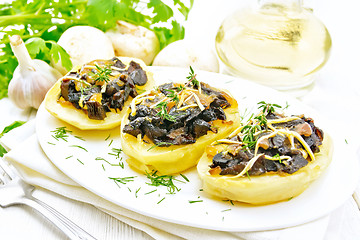 Image showing Potatoes stuffed with mushrooms on wooden board