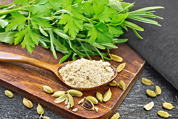 Image showing Cardamom ground in spoon on black board