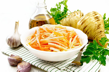 Image showing Salad of parsnip and carrot on board