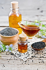 Image showing Oil kalingi in bottles and gravy boat on gray board