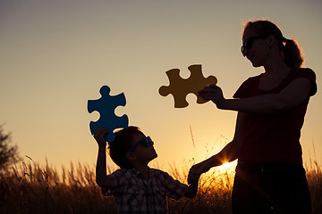 Image showing Mother and son playing at the park at the sunset time. 