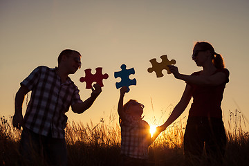 Image showing Happy family playing at the park at the sunset time.