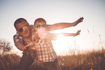 Image showing Father and son playing in the park at the day time.