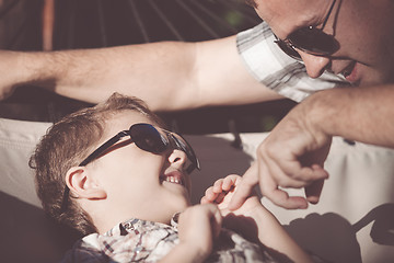 Image showing Father and son playing in the park at the day time.