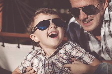 Image showing Father and son playing in the park at the day time.