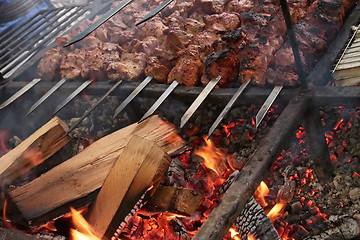 Image showing Pieces of meat are roasted on metal bars