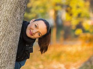 Image showing Woman Hiding Behind a Tree